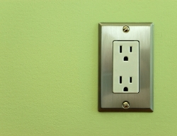 Electrical outlet on a green wall