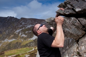 Man climbing rock overhang