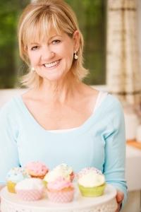 Woman Holding a Platter of Cupcakes