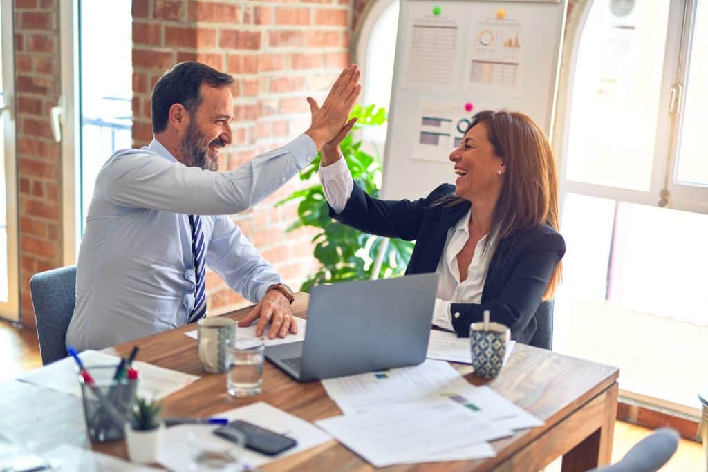 Businessman and businesswoman high-fiving